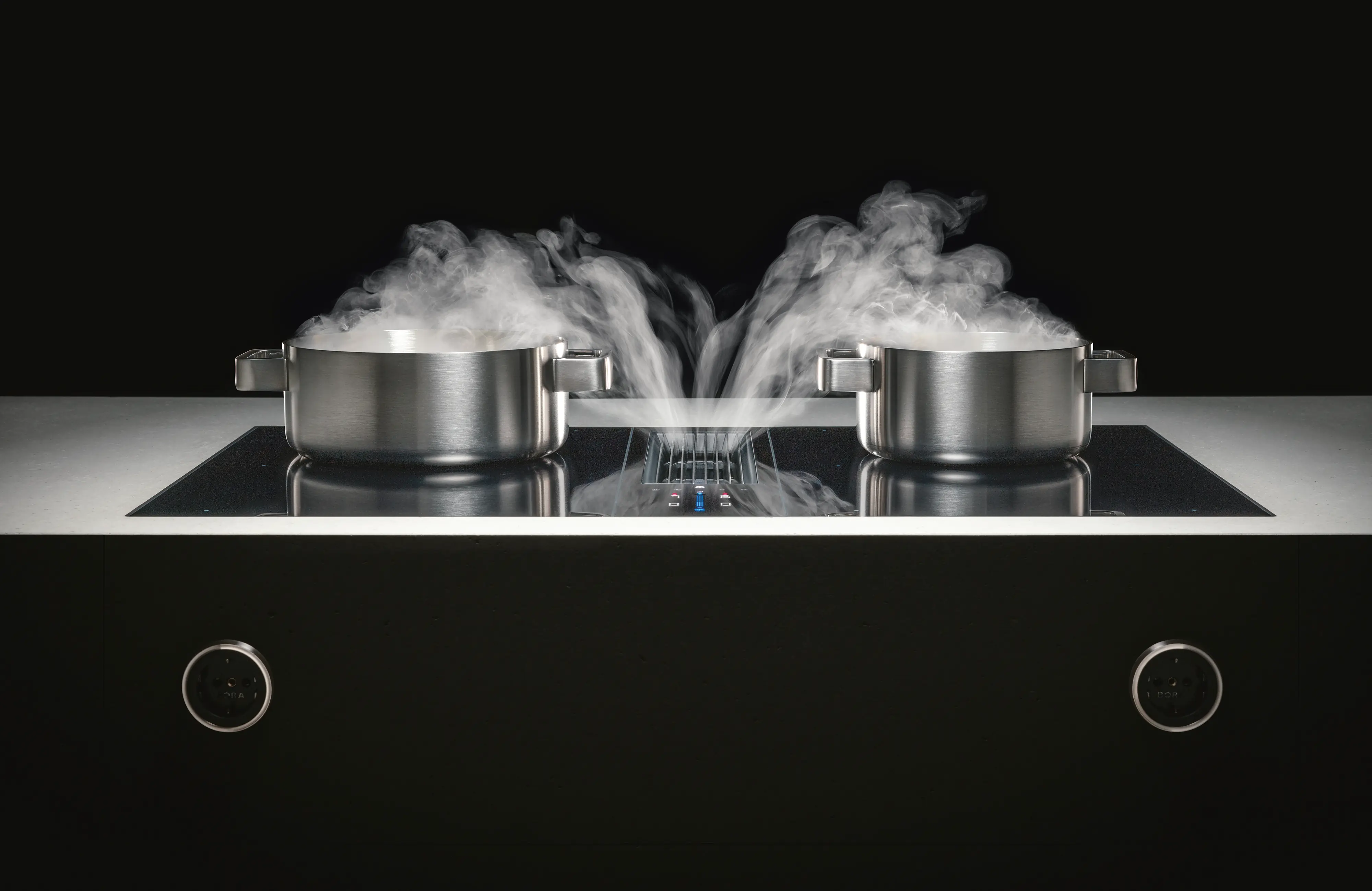 BORA cooktop with integrated extraction drawing steam down between two pans